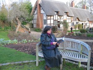 woman reading on bench outside